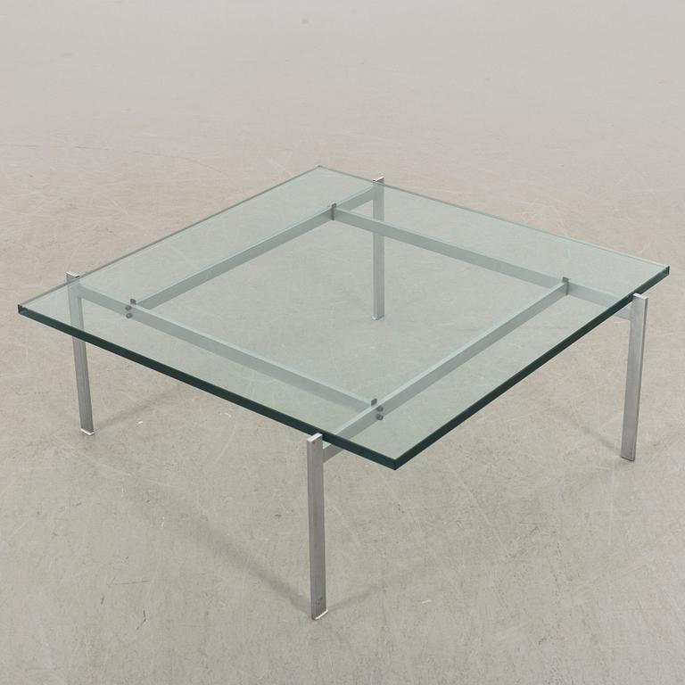 A Poul Kjaerholm PK61 glass table by Fritz Hansen.