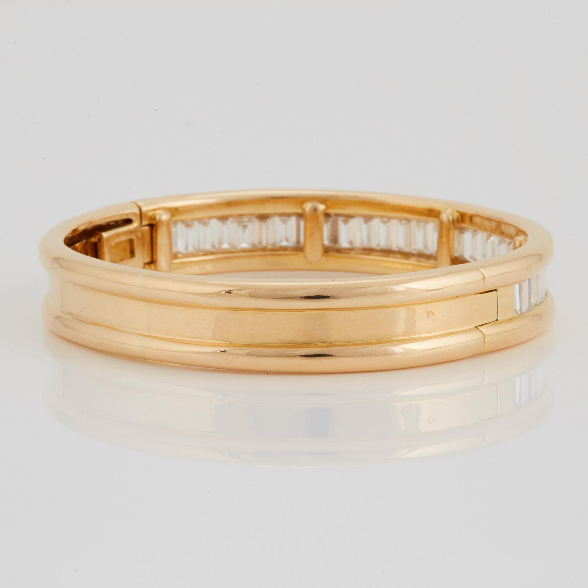 An 18K gold bracelet set with baguette-cut diamonds 7.715 cts according to engraving.