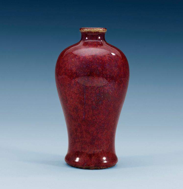 A ruby coloured Meiping vase, with areas of light celdon and blue colour, Qing dynasty (1644-1912).