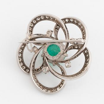 A white gold, cabochon cut emerald and diamond brooch.