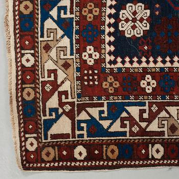 A RUG. A semi-antique Kuba/Shirvan. 165,5 x 129,5 cm (as well as one end with one cm flat weave).