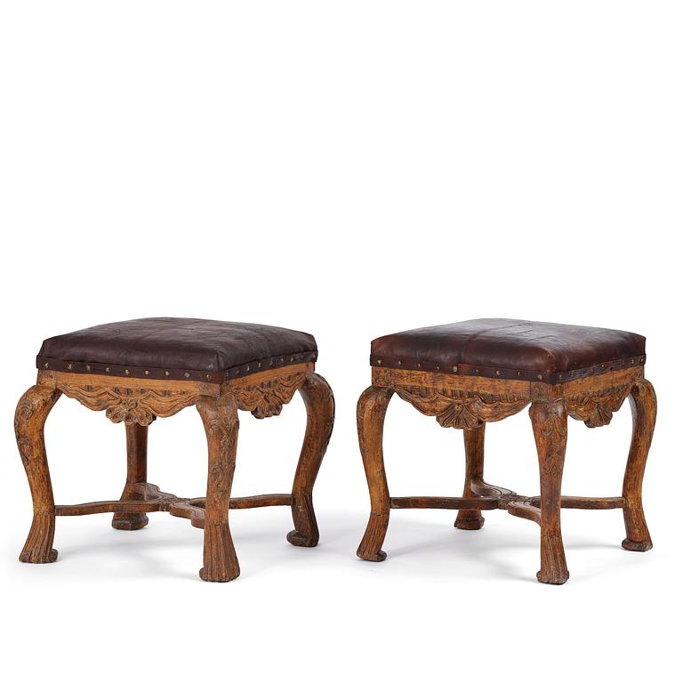A pair of carved stools in the manner of Jonas Granberg, Jämtland, Sweden, mid 18th century.
