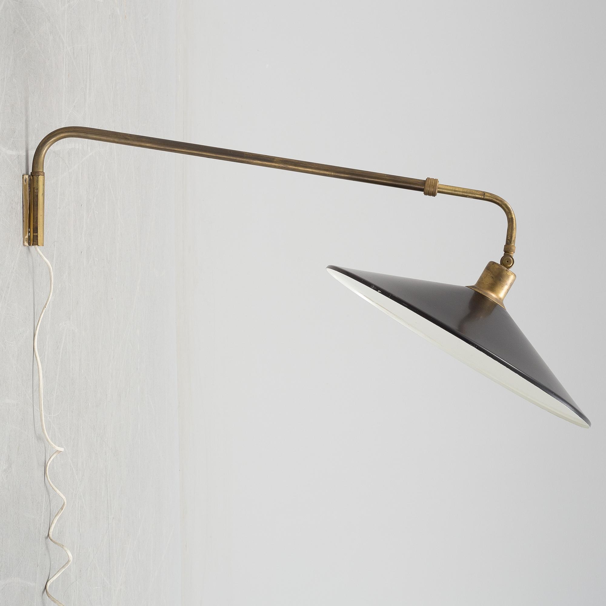 A 20th century brass and painted metal swing-arm wall light.