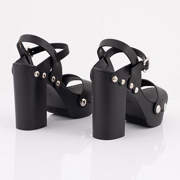 Prada, a pair of wood and leather sandals, size 37.