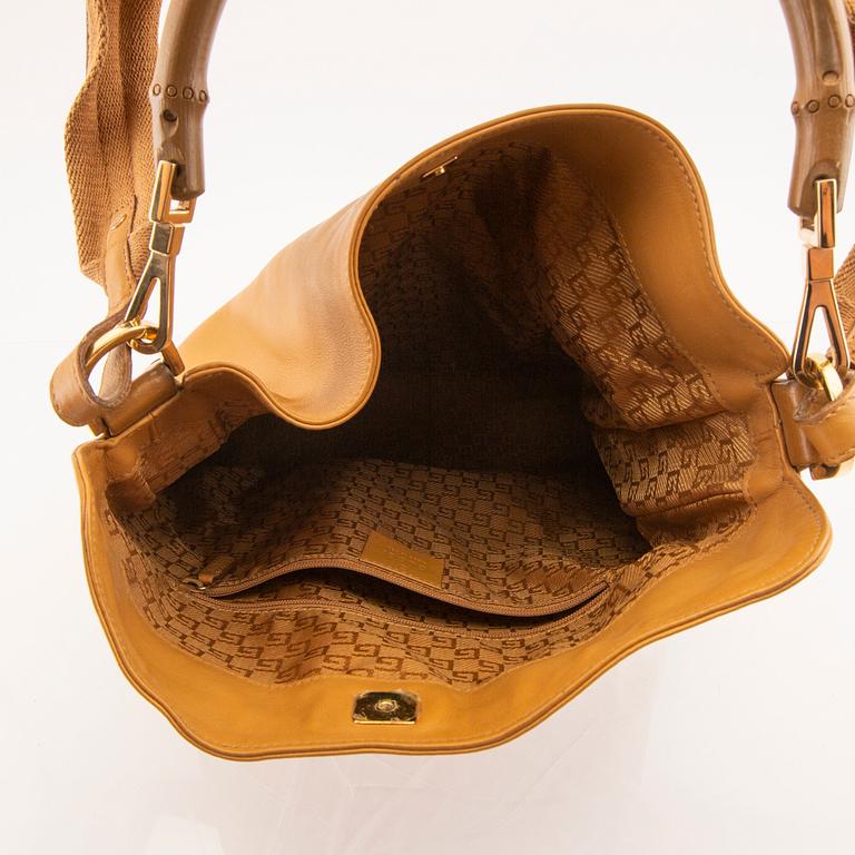 Gucci, a leather shoulder-strap bag.