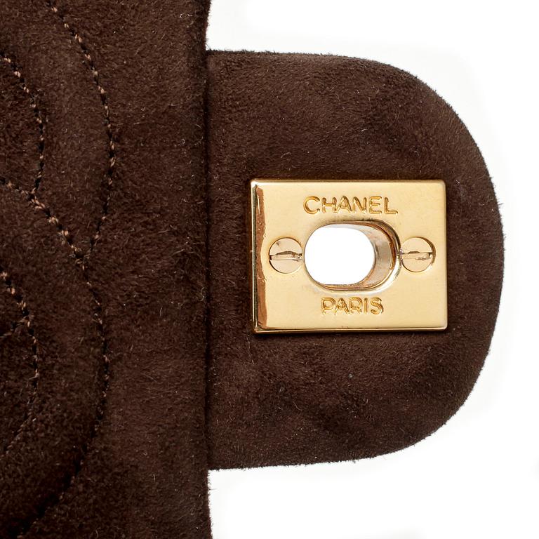 CHANEL, a brown suede quilted purse with shoulder strap.