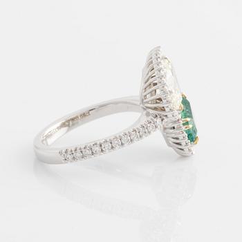 Ring with emerald-cut emerald and pear-shaped diamond, accompanying GIA diamond report.