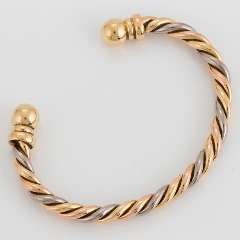 A Gaudy bangle in 18K tri color gold.