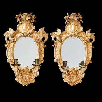 1263. A pair of Swedish Rococo 1740/50's two-light girandole mirrors.