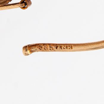 A pair of 14K gold earrings.