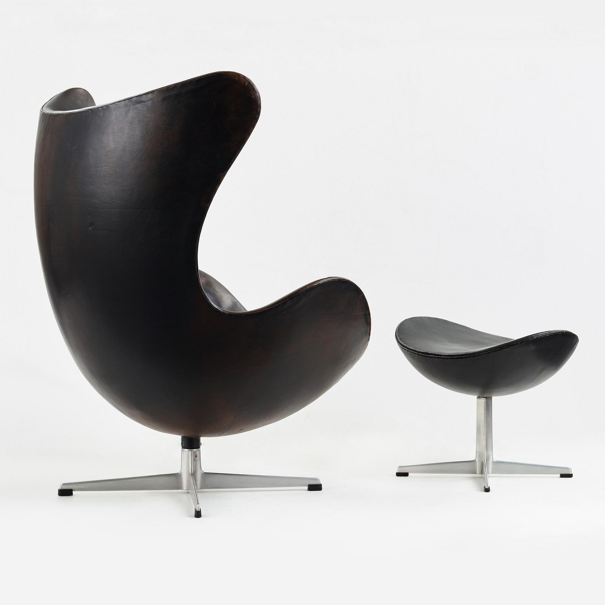 ARNE JACOBSEN, a black leather "Egg" chair with ottoman, Fritz Hansen, Denmark 1960's.