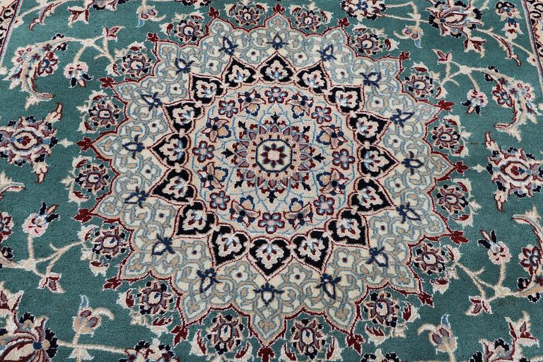 A Nain carpet, part silk, 6 laa, ca. 300 x 201 cm.