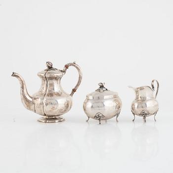A silver coffee pot, a creamer and a sugarbowl, including S:t Petersburg, Russia 1858.