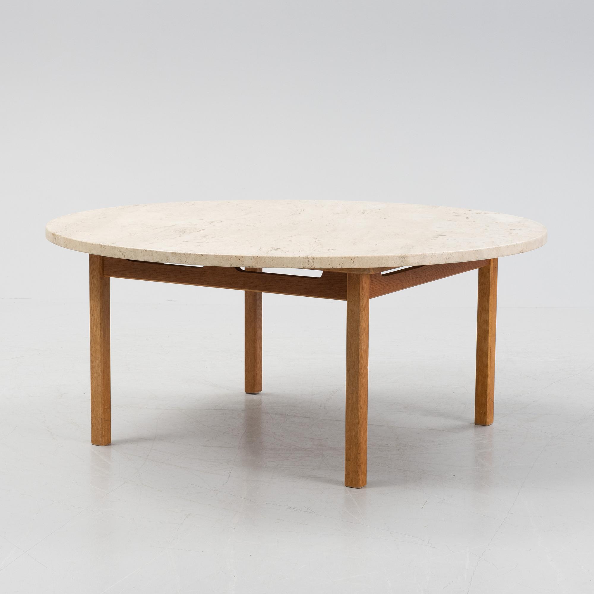 An oak coffee table with a later travertine top.