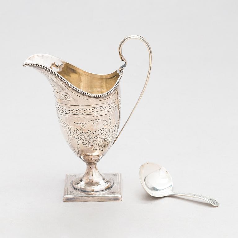 A sterling silver cream jug from London 1796, and a sterling spoon with maker's mark of Thomas Wallis II, London 1805.