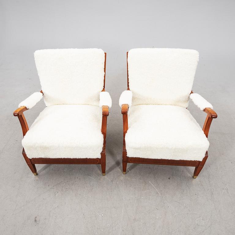 A pair of 1940s cheepskin armchairs.