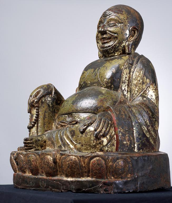 A large seated bronze figure of Budai, Ming Dynasty, dated to the fifth year of Jiajing (1526).