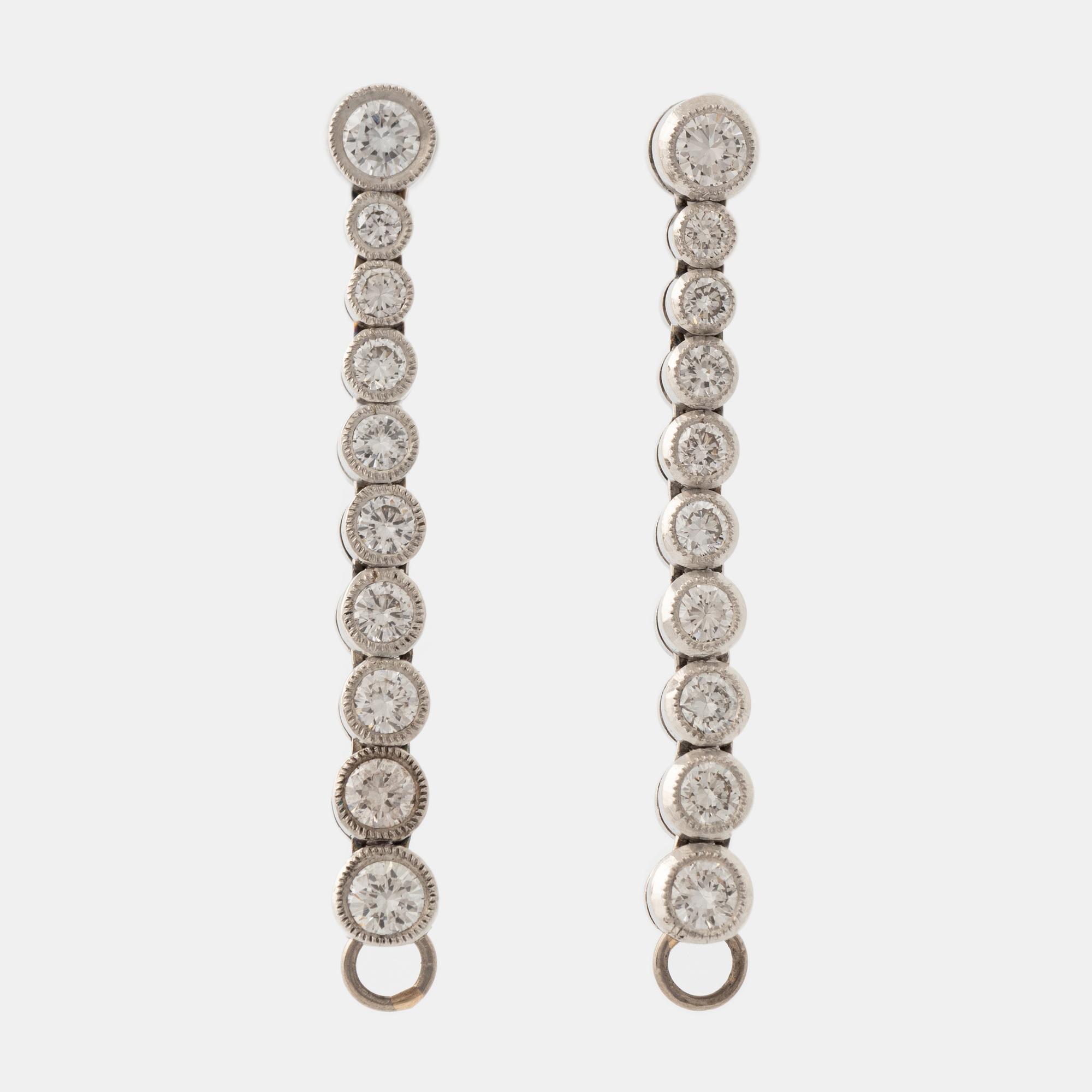 Platinum and brilliant cut diamond line earrings.