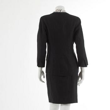 CHANEL, a three-piece suit consisting of jacket, top and skirt.