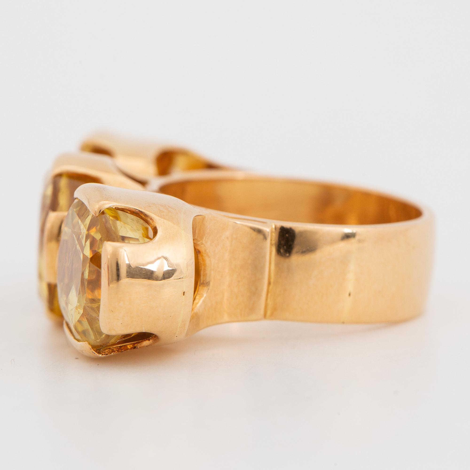 18K gold and yellow sapphire three-stone ring.