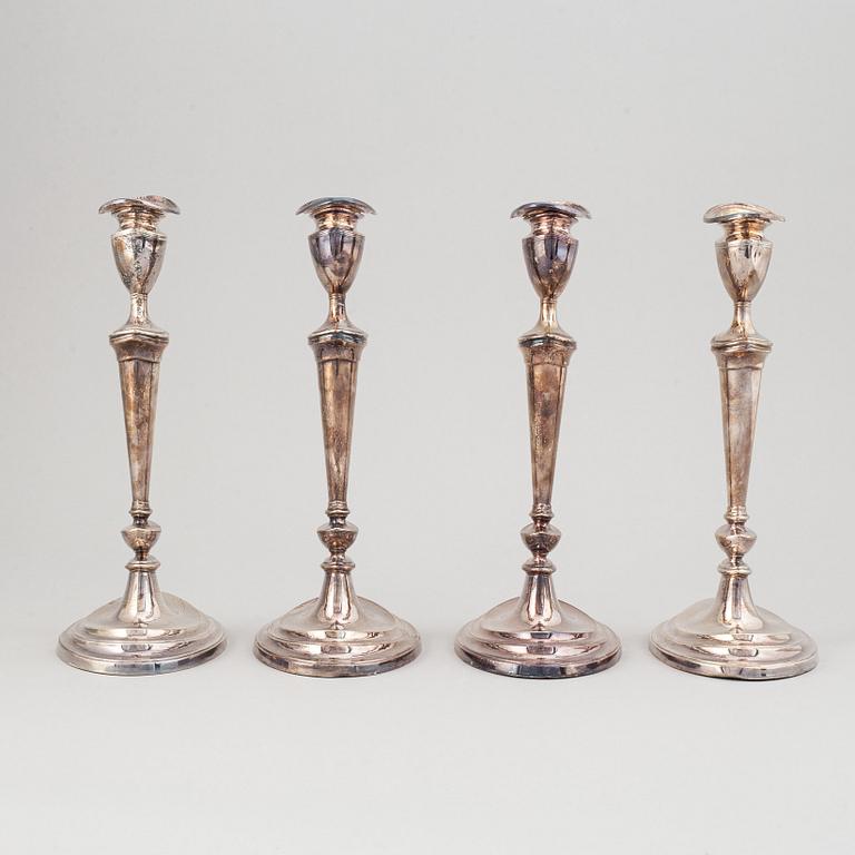 A set of four English 19th century silver-plated candlesticks.