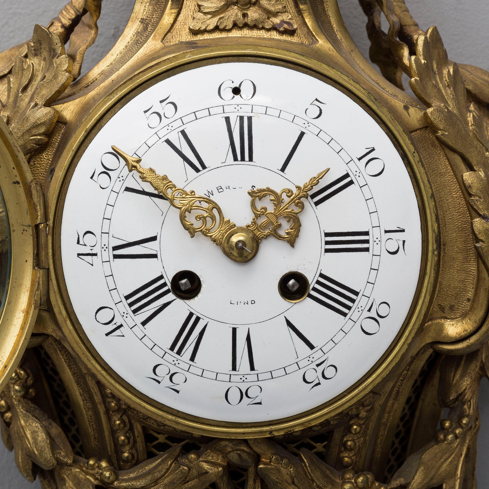 A brass wall clock marked A.W. Bruuns eftr, Lund from around year 1900.