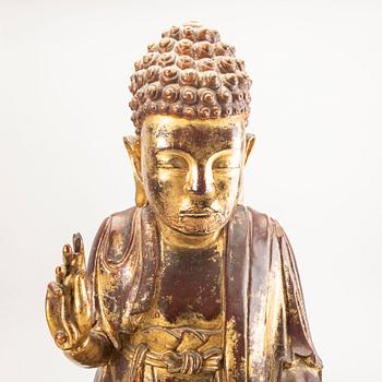 A large gilt and lacquered figure of a seated buddha, Qing dynasty, 19th Century.