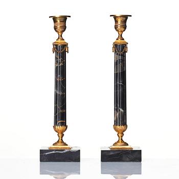 A pair of late Gustavian Portor marble candlesticks, late 18th century.