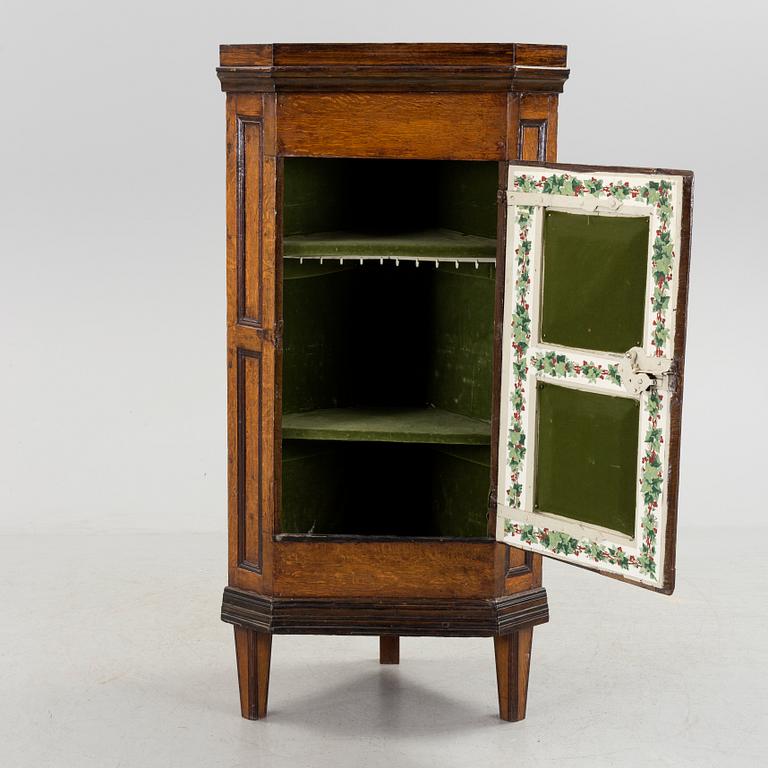 An 18th century corner cabinet.