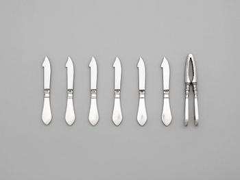 570. A set of six Georg Jensen sterling shell fish knives and a nut cracker, 'Continental', Copenhagen 1933-44 and 1930.