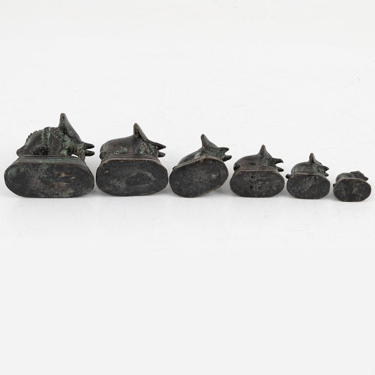Six bronze opium weights, China/Southeast Asia, around 1900.