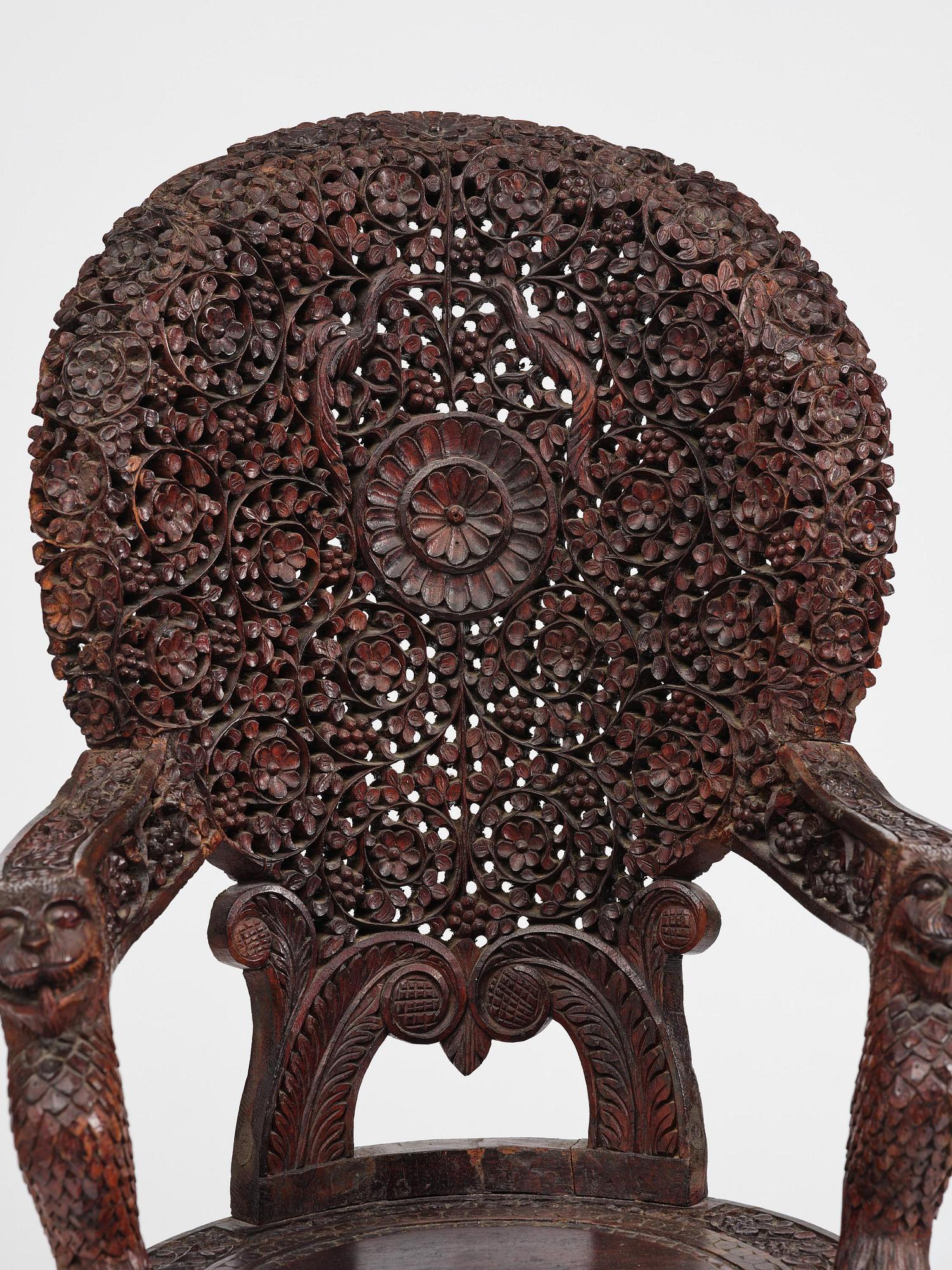 A pair of carved 'blackwood' armchairs, Bombay presidency, British Raj, circa 1880.