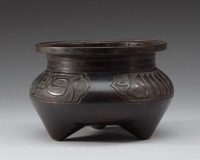 A bronze tripod censer, Qing dynasty.