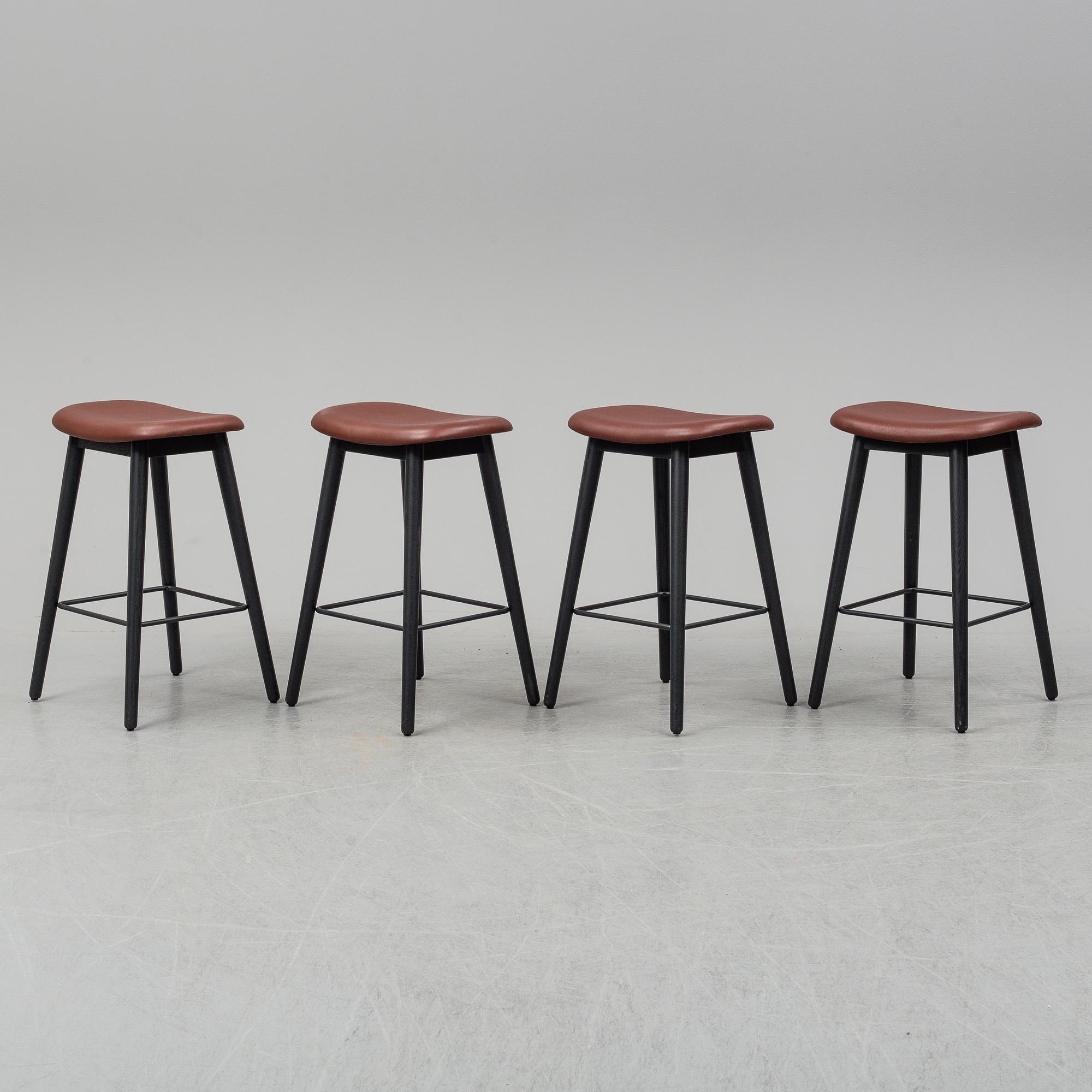 Four contemporary leather upholstred stools by Berlin & Iskos for Muuto.