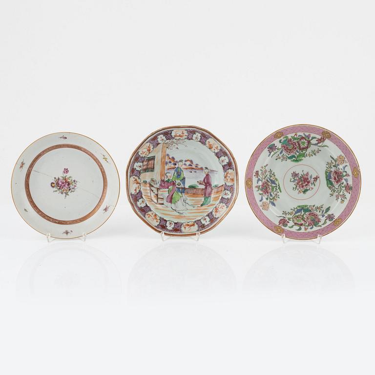 A group of seven Chinese porcelain plates and a charger, 18th / 19th Century.