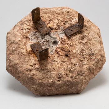 A limestone and iron sundial dated 1732.