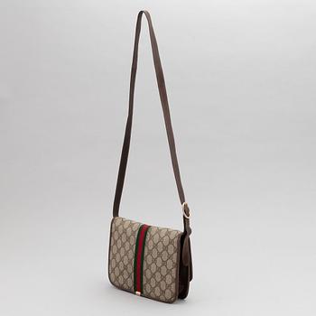 Gucci, a canvas handbag.