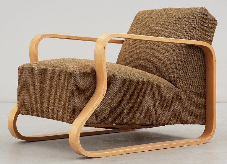 An Alvar Aalto laminated birch 'padded Paimio chair', upholstered in yellow and black fabric.