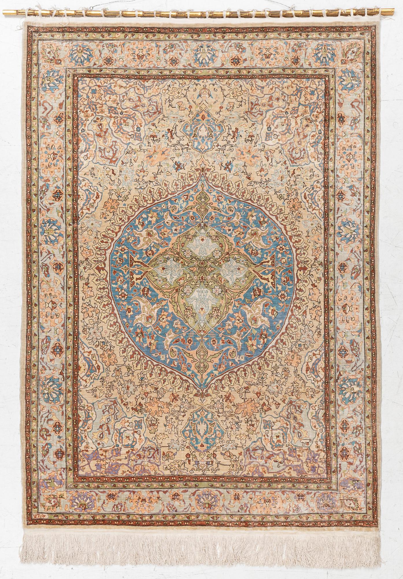 An oriental, silk rug, signed, c. 175 x 125 cm.