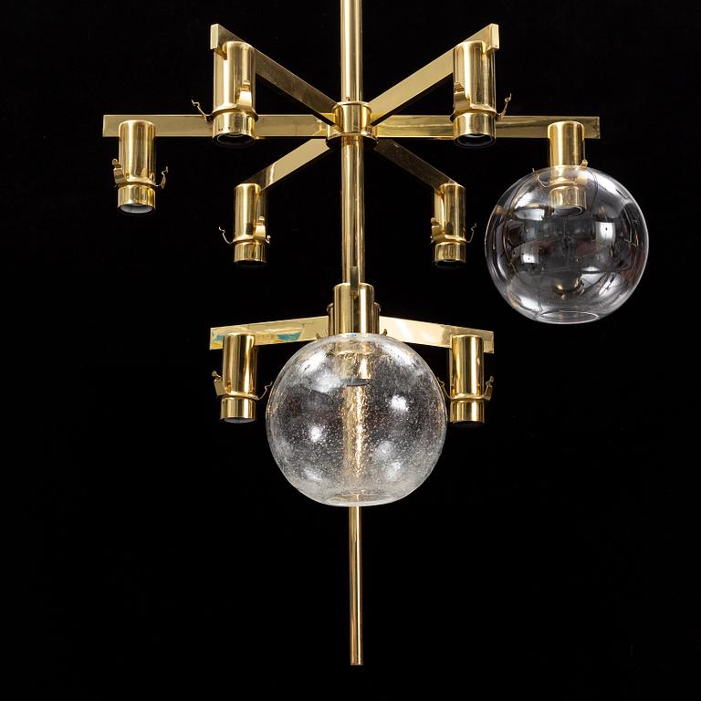A brass chandelier with two glass globes by Hans-Agne Jacobsson, Markaryd.