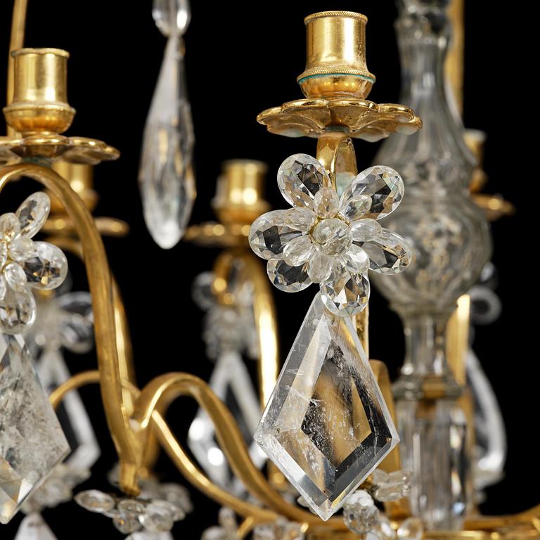 A near pair of Franch Louis-XV-style nine-branch gilt bronze and rock crystal chandeliers, later part 19th century.