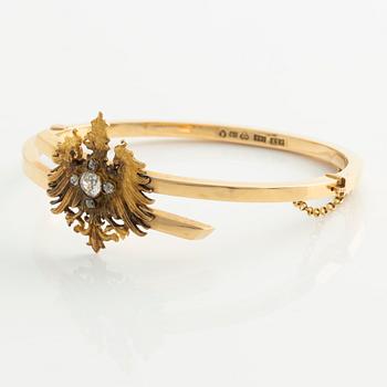 Armband 18K guld med en fastlödd del av en broschnål i guld med gammalslipade diamanter, i form av en örn.