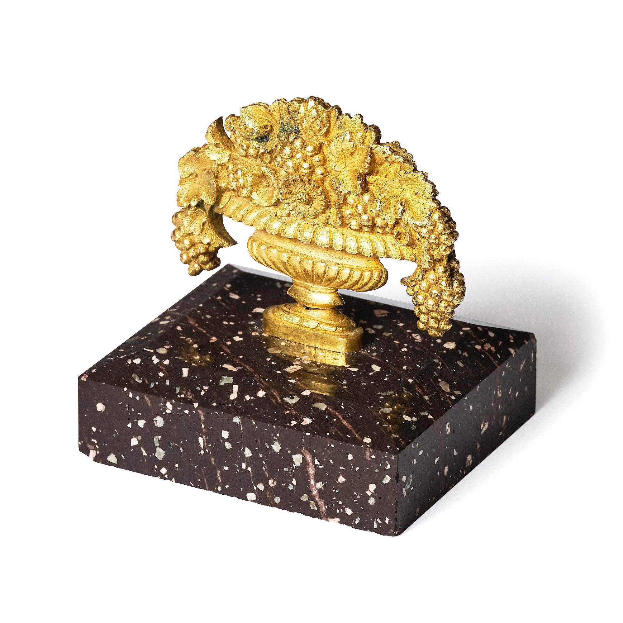 An Empire 'Loka-Risberg'-porhyry and ormolu paperweight, Älvdalen, early 19th century.