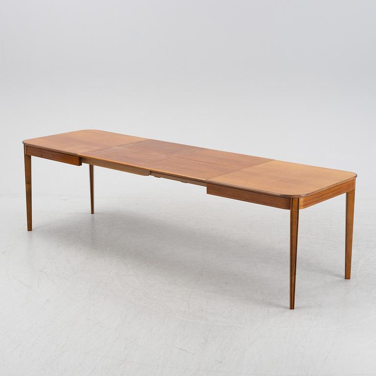 A 1950's/60's mahogany and mahogany veneered dining table.