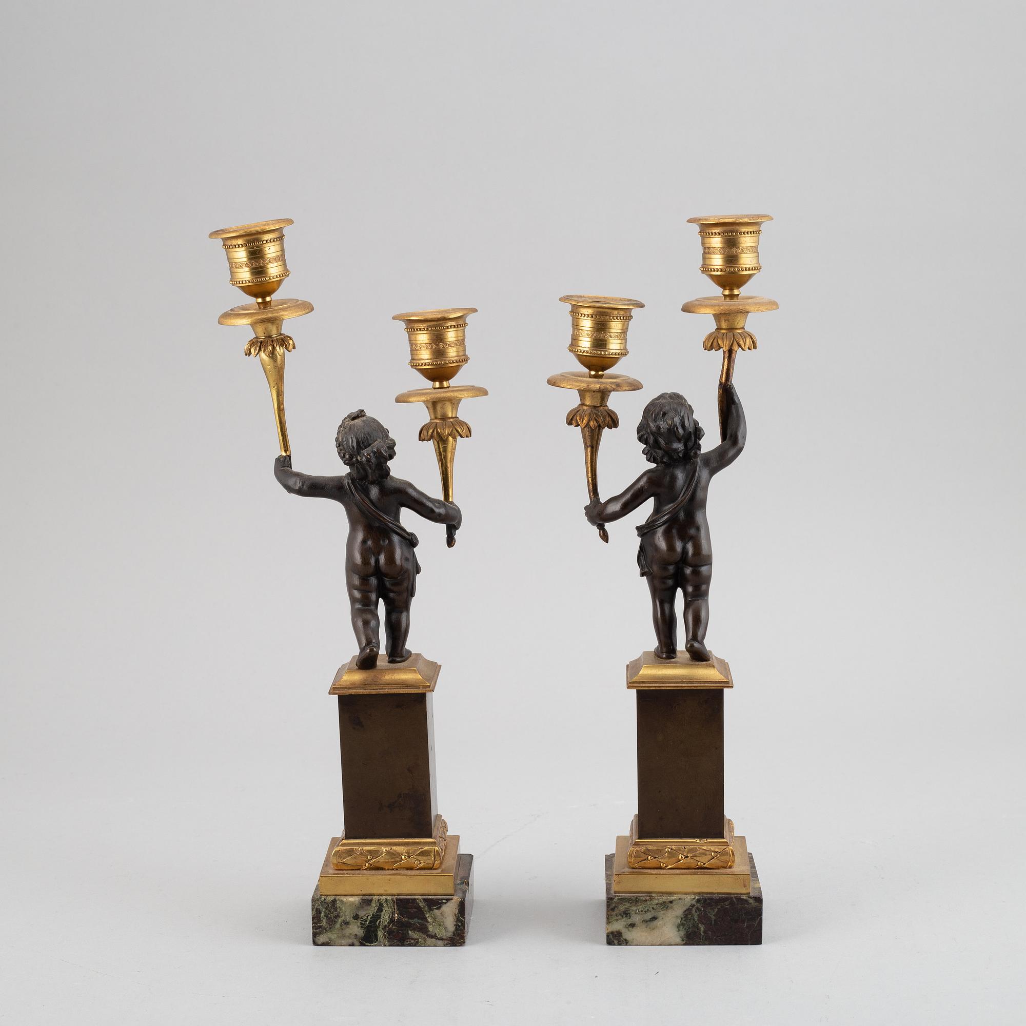 A pair of bronze empire style candleabra, 20th century.