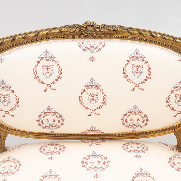 A Gustavian style sofa with two armchairs and two chairs, 20th century.