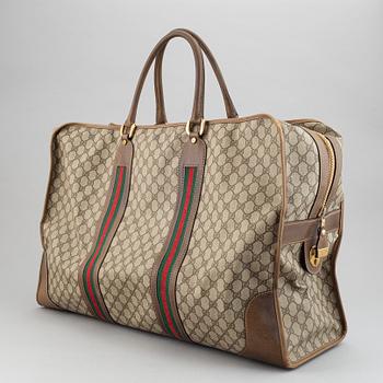 Gucci, a canvas weekend bag.