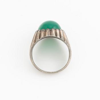 Silver ring with a green cabochon-cut stone.