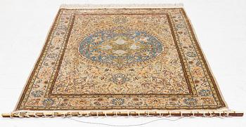 An oriental, silk rug, signed, c. 175 x 125 cm.