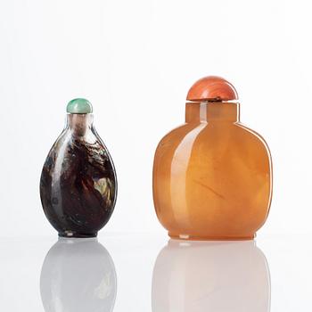 Two Chinese snuff bottles with stoppers, 20th Century.